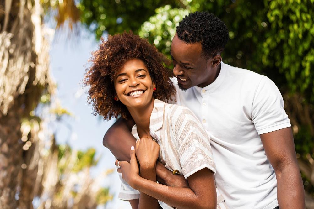 young couple hugging outside | veneers kauai