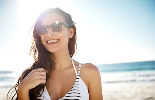 A woman smiling on the beach