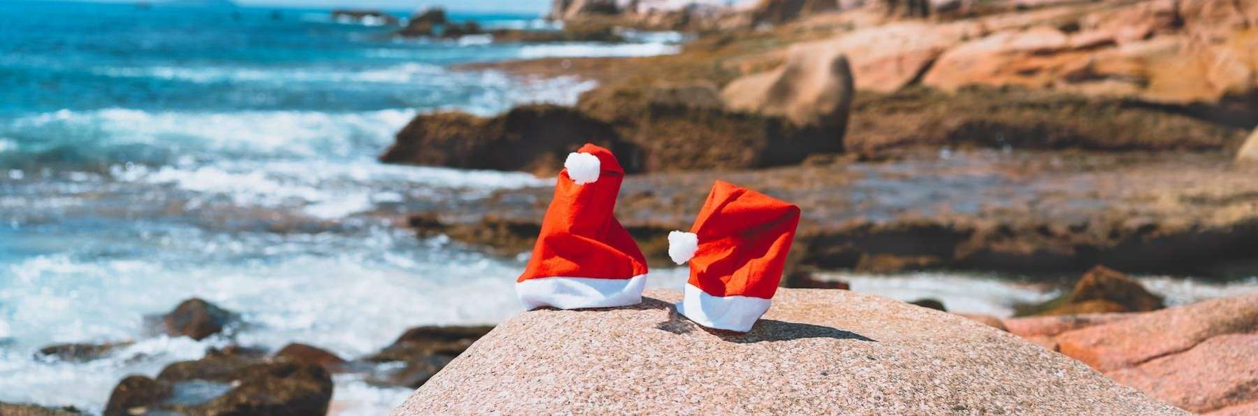 close up of santa hats on beach | family dentist kauai