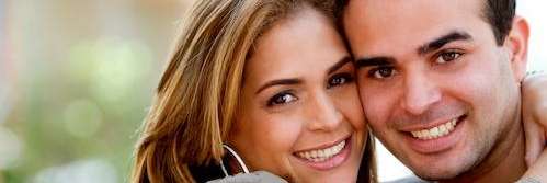 2 people smiling and hugging | Kalaheo Dentist