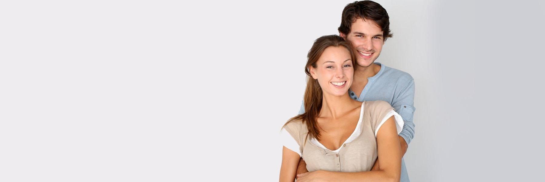 Young couple smiling & hugging l Dental Implants Kalaheo HI