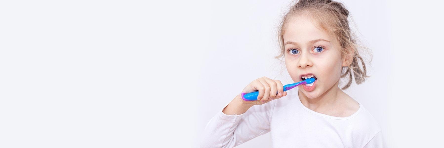 little girl brushing her teeth