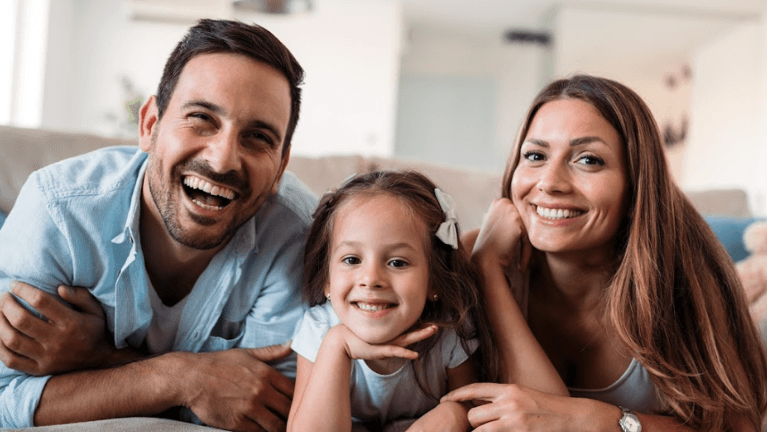 Family smiling in their home | Koloa Dentist