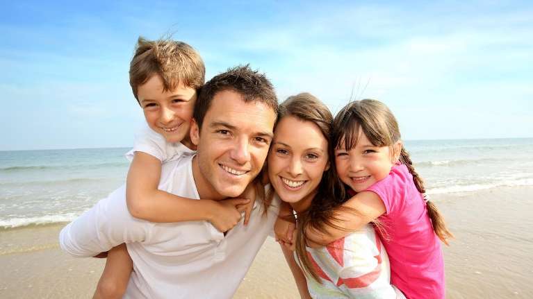 family of four on beach | kauai dentist