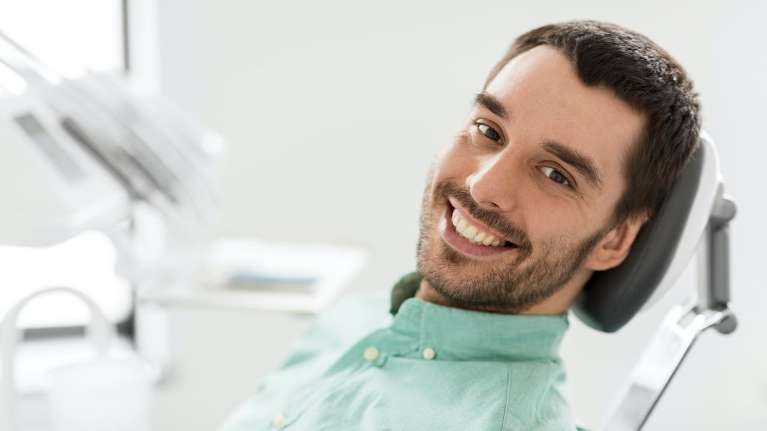 man sitting in dentist exam chair | teeth cleaning kalaheo