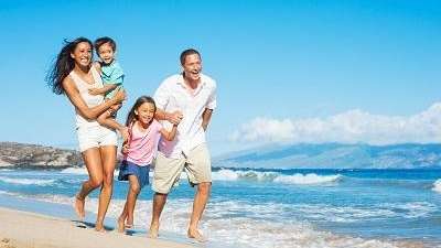 family of four running on beach | dentist poipu hi
