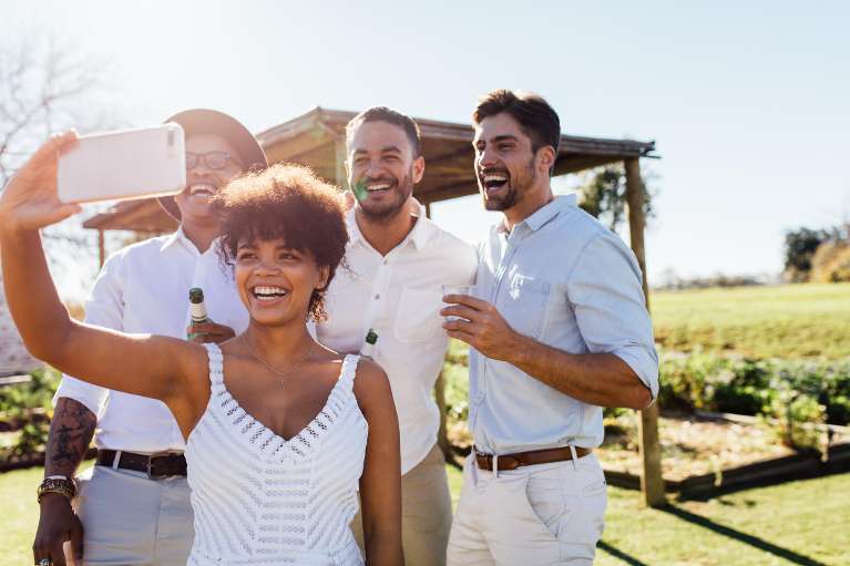 group of friends taking a photo outside | veneers kauai