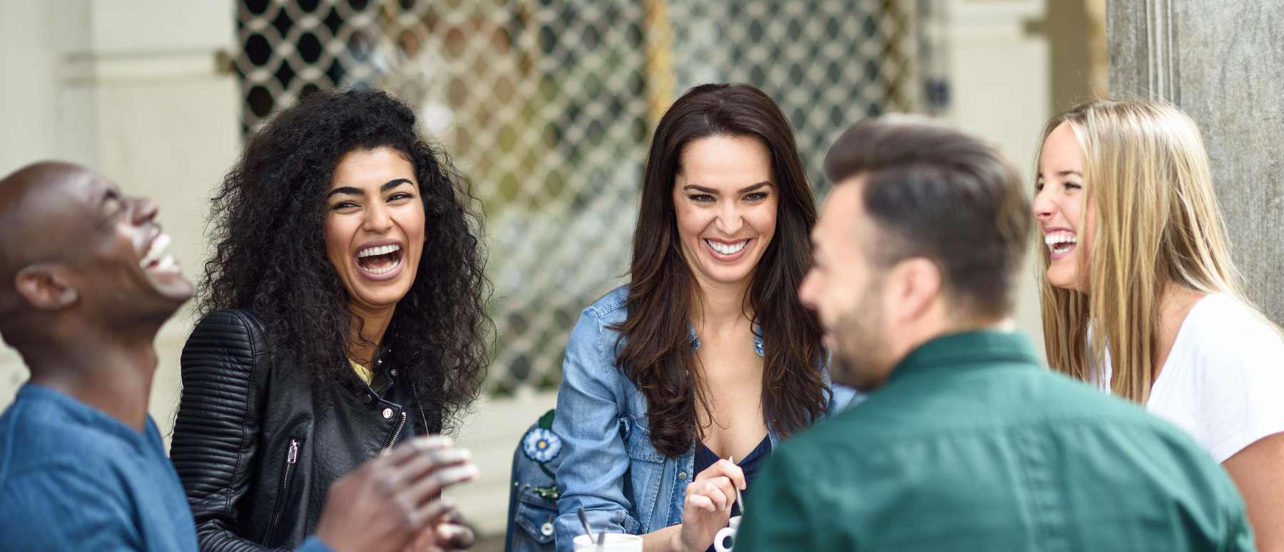 Group of friends smiling confidently, showing off their bright, flawless teeth